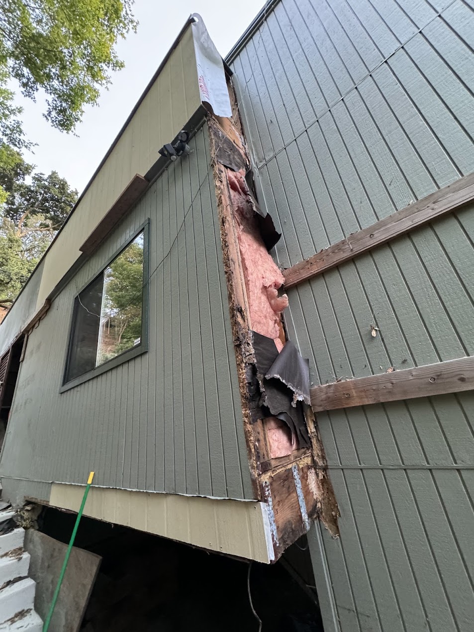 Old siding removed — rot exposed